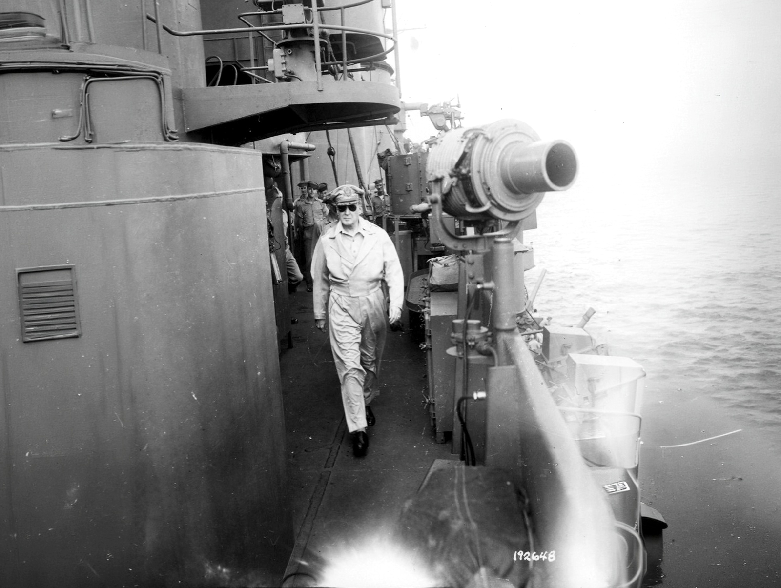General Douglas MacArthur walks to the flag bridge of the USS Nashville in Humboldt Bay off Hollandia, New Guinea, April 22, 1944